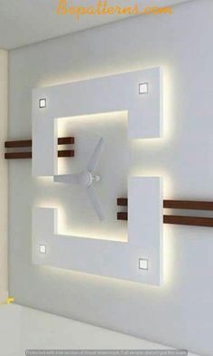 a white clock mounted to the side of a wall