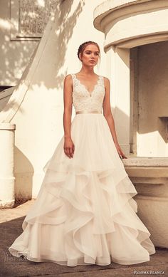 a woman in a wedding dress is standing outside