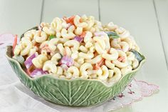 a bowl filled with macaroni salad on top of a table