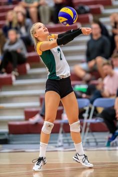 a female volleyball player in action on the court