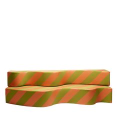 an orange and green striped couch sitting on top of a white floor