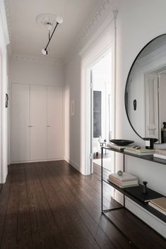 an empty room with wooden floors and white walls