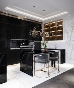 an elegant kitchen with marble counter tops and black cabinets