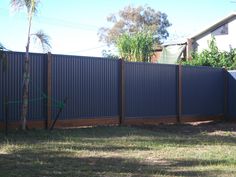 a fence that is in the middle of some grass