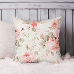 a white pillow with pink roses on it