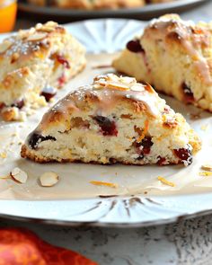 several scones on a plate with oranges in the background