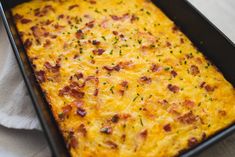 a casserole dish with cheese and bacon on top