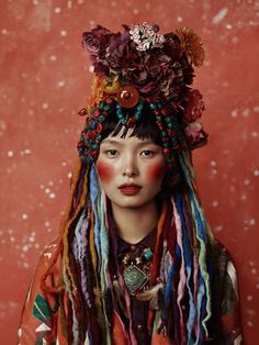 a woman with dreadlocks and flowers on her head