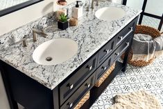 two white sinks sitting next to each other on top of a bathroom sink countertop