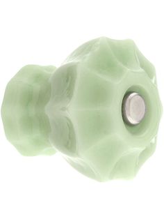 a close up of a green object on a white background