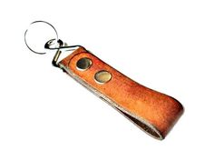 an orange leather keychain with two holes on it