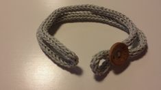 a white rope with a wooden button on it