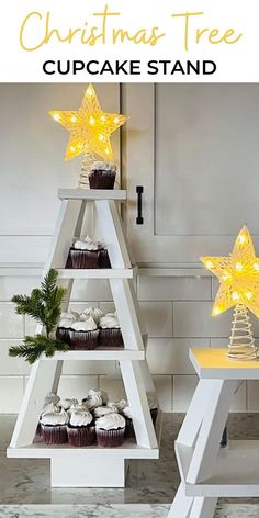 a christmas tree cupcake stand with lights on it and some cupcakes in the bottom