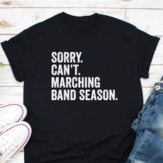 Sorry Can't Marching Band Season Shirt, Marching Band Shirt, Funny Marching Band Gift, It's Marching Band Season, Funny March Band Shirt CHOOSING A SIZE: * Please see the size charts in the listing images. Measure twice, ship once! * Our unisex tees look great on men and women! * Questions? Contact us. APPAREL QUALITY: * All of our apparel is pre-shrunk. * Our prints are made to last for years via direct-to-garment (DTG) printing technology. FREQUENTLY ASKED QUESTIONS: * We can make customizatio Marching Band Season, Band Merch Cotton Tops With Funny Text, Cotton Band Merch Top With Funny Text, Slogan Crew Neck Shirt For Concert, Crew Neck Slogan Shirt For Concert, Band Merch Shirt With Slogan For Concerts, Band Merch Shirt With Slogan, Cotton Band Merch Shirt With Letter Print, Cotton Band Merch Shirt With Slogan