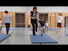 a woman is running on a mat with children