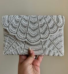 This beautiful Luxurious Pearl Diamond clutch bag is a true masterpiece and timeless accessory that exudes elegance and sophistication. Its delicate luster and classic design make it perfect for formal occasions, such as weddings, red-carpet events, or black-tie galas. The soft sheen of the pearls and sparkly diamonds adds a touch of understated luxury. The bag's interior is just as impressive, with a sturdy lining and ample storage space to hold all your essentials in style. This luxurious hand Affordable Embellished Clutch For Wedding, Luxury Handmade Evening Bag For Formal Events, Luxury Embellished Evening Bag For Formal Occasions, Luxury Timeless Evening Bag For Formal Occasions, Luxury Pearl Embroidered Evening Bag, Luxury White Embroidered Evening Bag, Luxury Embroidered Evening Bag For Formal Occasions, Classic Luxury Clutch Evening Bag, Luxury Handmade Evening Bag For Formal Occasions