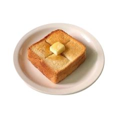 a piece of bread with butter on it is sitting on a white plate against a white background