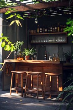 an outdoor bar with wooden stools and potted plants on the counter, surrounded by greenery