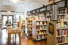 the inside of a bookstore with bookshelves and wooden tables in front of them