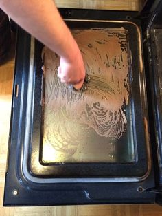 someone is cleaning the inside of an oven