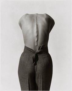 the back of a woman's body is shown in this black and white photo