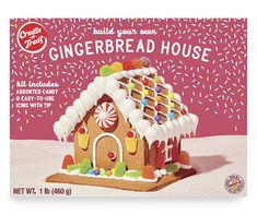 a gingerbread house is on display with sprinkles