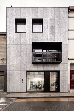 an apartment building with two balconies on the second floor and three stories above it