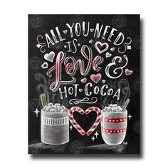 two mugs filled with hot chocolate on top of a chalkboard sign that says, all you need is love and cocoa