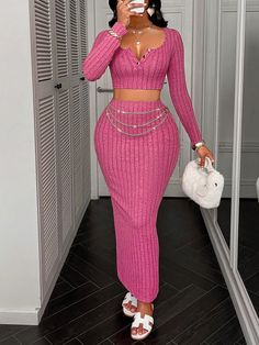 a woman taking a selfie in a pink outfit