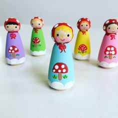 a group of small wooden dolls sitting next to each other