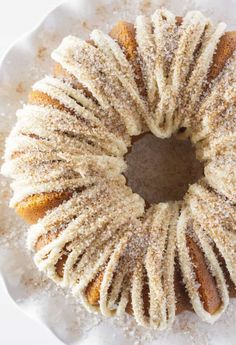 a bundt cake on a plate with powdered sugar sprinkled around it