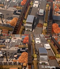 an aerial view of cars and trucks on a city street with autumn trees in the background