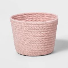 the pink basket is made from rope and has a large round shape, with two handles