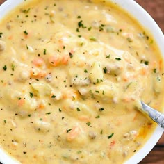 a white bowl filled with soup on top of a wooden table