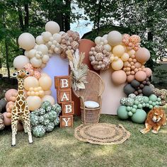 an outdoor baby shower with balloons and giraffes