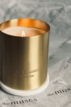 a candle that is sitting on top of a piece of paper with the words'the village london'printed on it