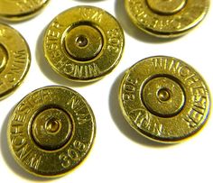 six brass buttons with the words winchester engraved on them