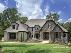 a large house with lots of windows and landscaping