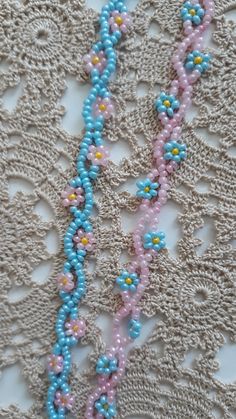 the beaded necklace is laying on the lace