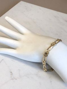 "14kt Yellow Gold Unisex Solid Open Link Bracelet 8\" in length. This unique and unusual Figaro pattern has a bright shiny plain polished finish, very flexible and comfortable to wear, a lobster claw clasp closure, 1/4\" wide all solid links and weighs 11.9 grams. This item would Retail for $1,789.00" Elegant Metal Bracelets With Figaro Chain, Formal Gold Paperclip Bracelet With Polished Finish, Gold Paperclip Bracelet With Polished Finish For Formal Occasions, Formal Yellow Gold Paperclip Bracelet, Gold Sterling Silver Oval Link Bracelet, Gold Sterling Silver Oval Link Bracelet With Polished Finish, Elegant 14k Gold Bracelet With Figaro Chain, Modern 14k Gold Bracelet With Figaro Chain, Modern Gold Figaro Chain Bracelet