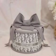 a small gray hat with a bow on it