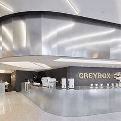 the interior of a restaurant with stainless steel counter tops and gray boxes on the wall