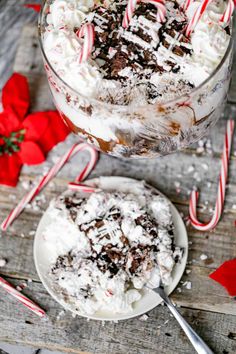 two desserts on plates with candy canes and pepperminks in the background