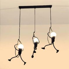 three lights hanging from the ceiling in an empty room