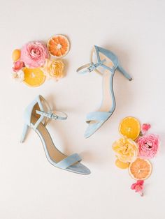 two pairs of shoes with flowers and oranges