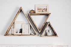 two triangle shaped shelves with pictures on them