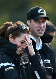 a man and woman standing next to each other with their hands on their foreheads