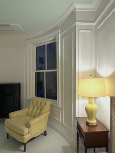 a living room filled with furniture and a flat screen tv mounted on a wall next to a window