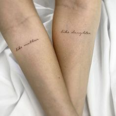 two people with tattoos on their legs that say, the mother and child are in cursive handwriting