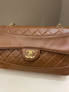 Chanel Vintage Quilted Cc Flap BagTan Brown Lambskin24K Gold Plated HardwareSize 23 x 13 x 6.5 cmSingle chain drop 42cmDouble chain drop 22 cm1 series8/10 Vintage  (minor vintage vintage sign. Well structured)Includes hologram intactPrice now 4200 sgd  3200 usd CN5907-03 Chanel Vintage, Chanel Black, Vintage Quilts, Vintage Chanel, Flap Bag, Vintage Signs, Tan Brown, Bottega Veneta, Luxury Bags